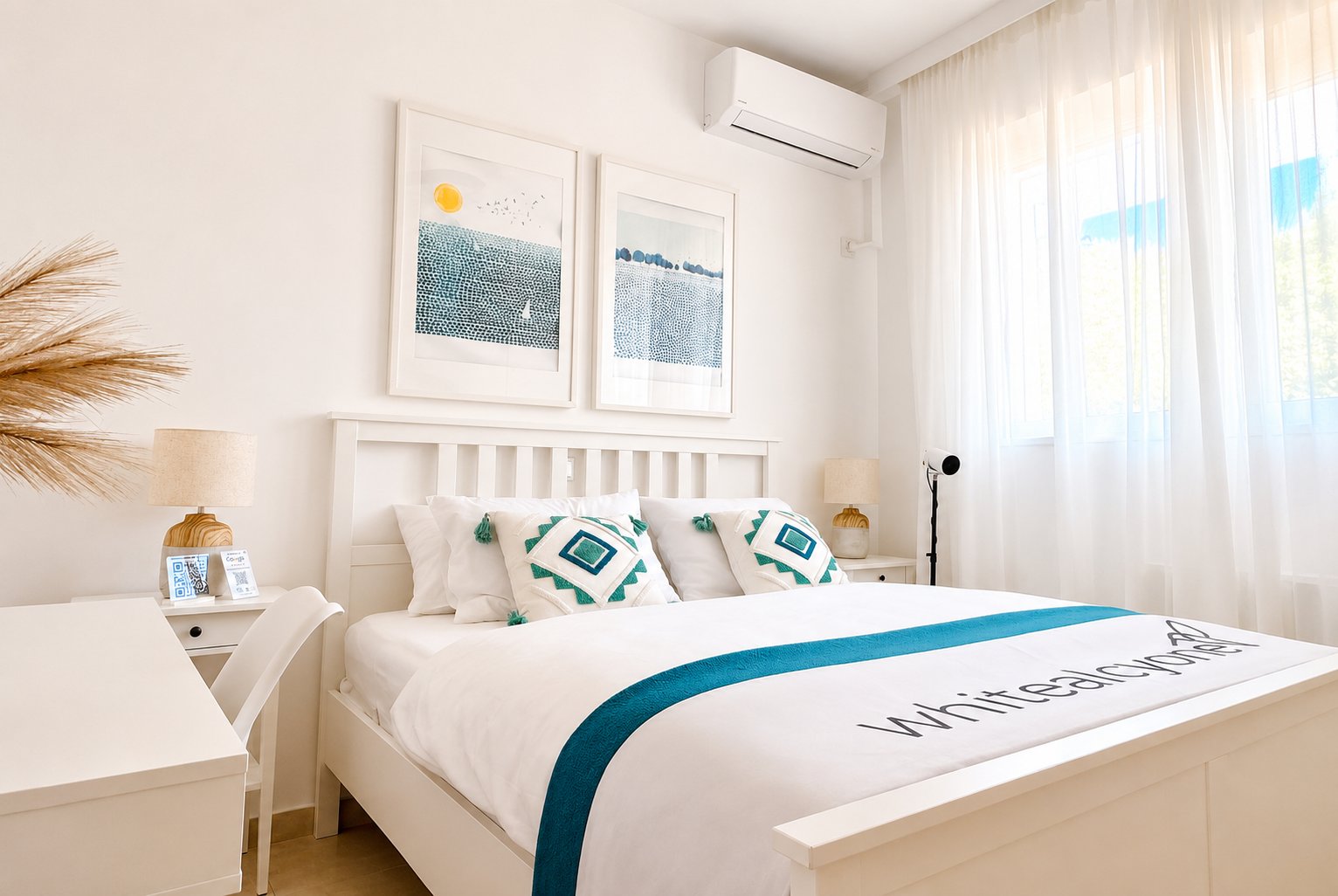 Bright and comfortable bedroom with Whitealcyone branding, perfect for relaxing after exploring Artemida or attending events at Metropolitan Expo.