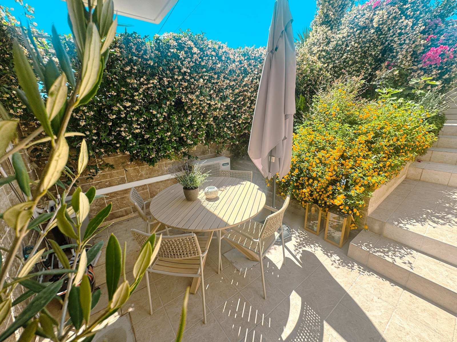 Cozy private patio and garden at Whitealcyone Fit & Zen Apartment, offering an outdoor oasis for guests staying near Athens Airport.